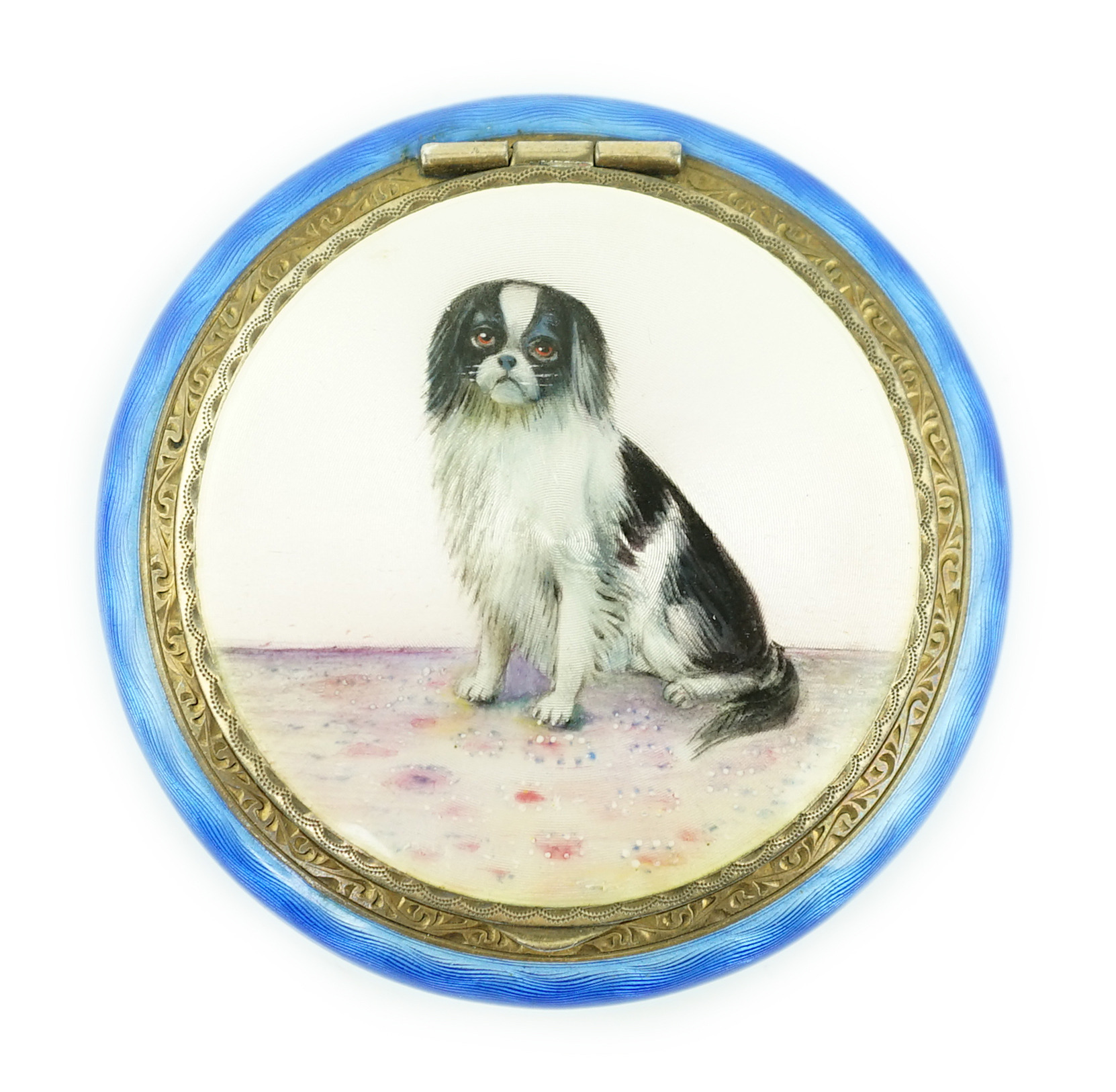 A George V silver gilt and enamel circular compact, decorated with a seated dog, import marks for P.H. Vogel